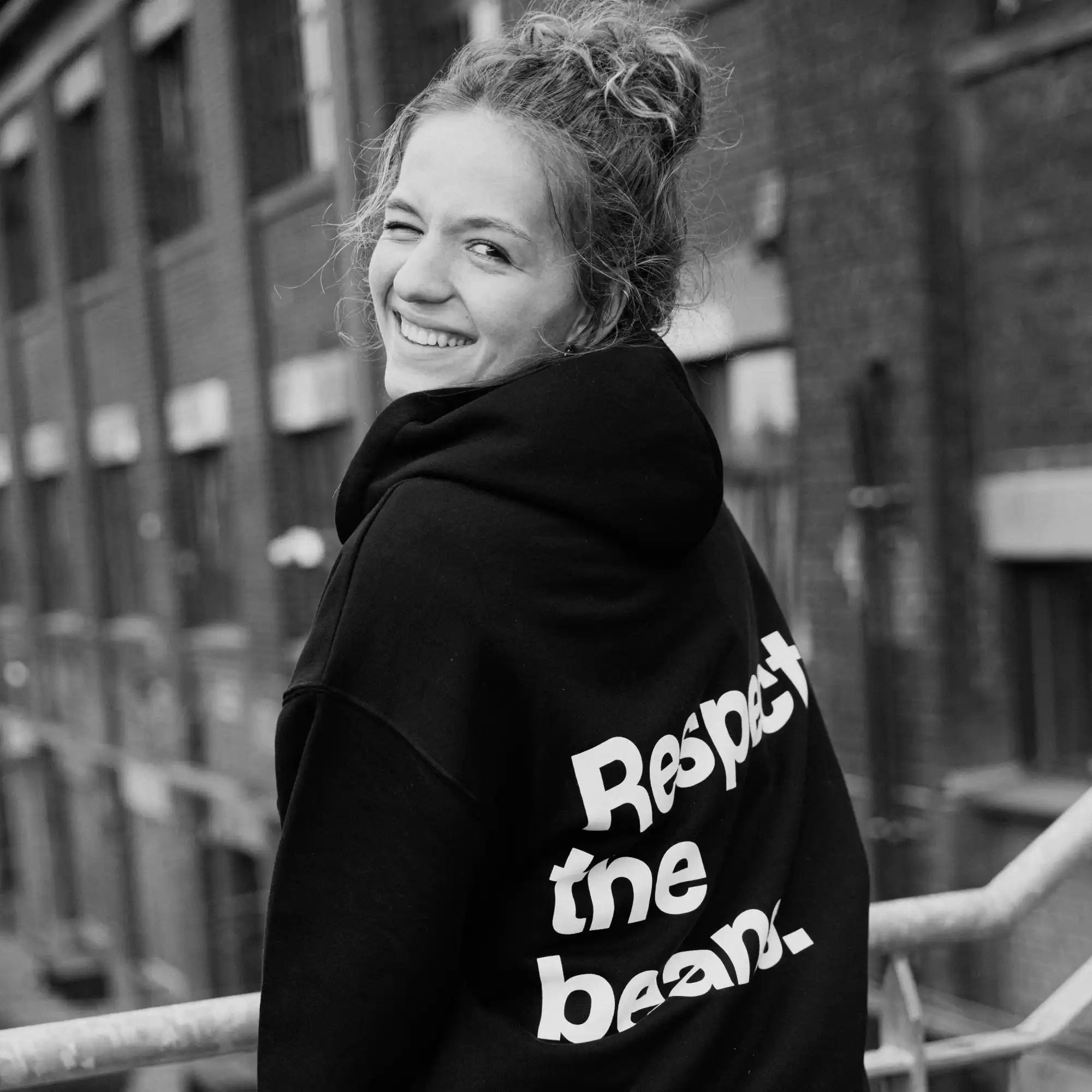 Black hoodie with ’respect the bean’ slogan on back.